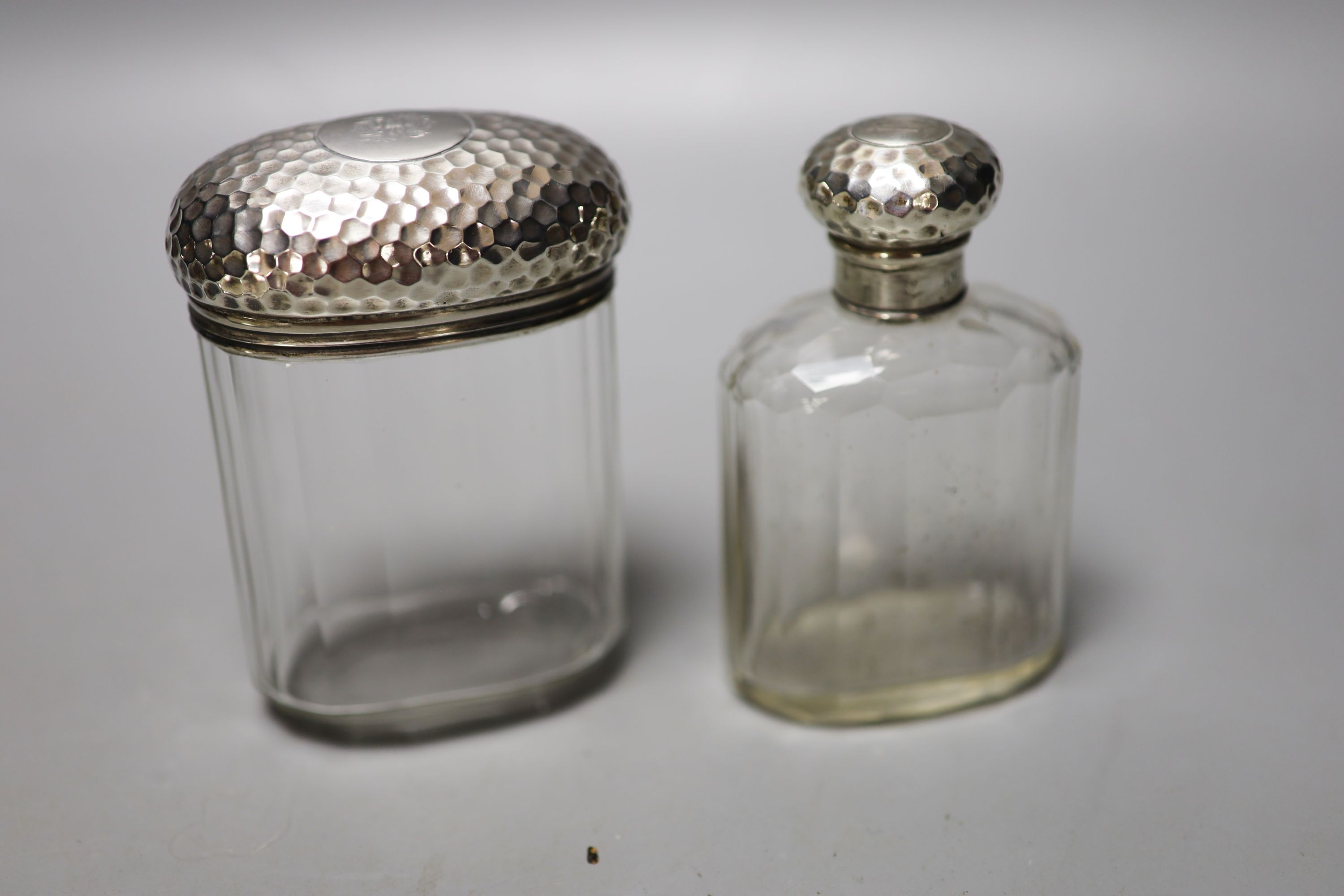 Six assorted silver mounted glass toilet jars, including a powder bowl and a Chinese white metal tot(a.f.).